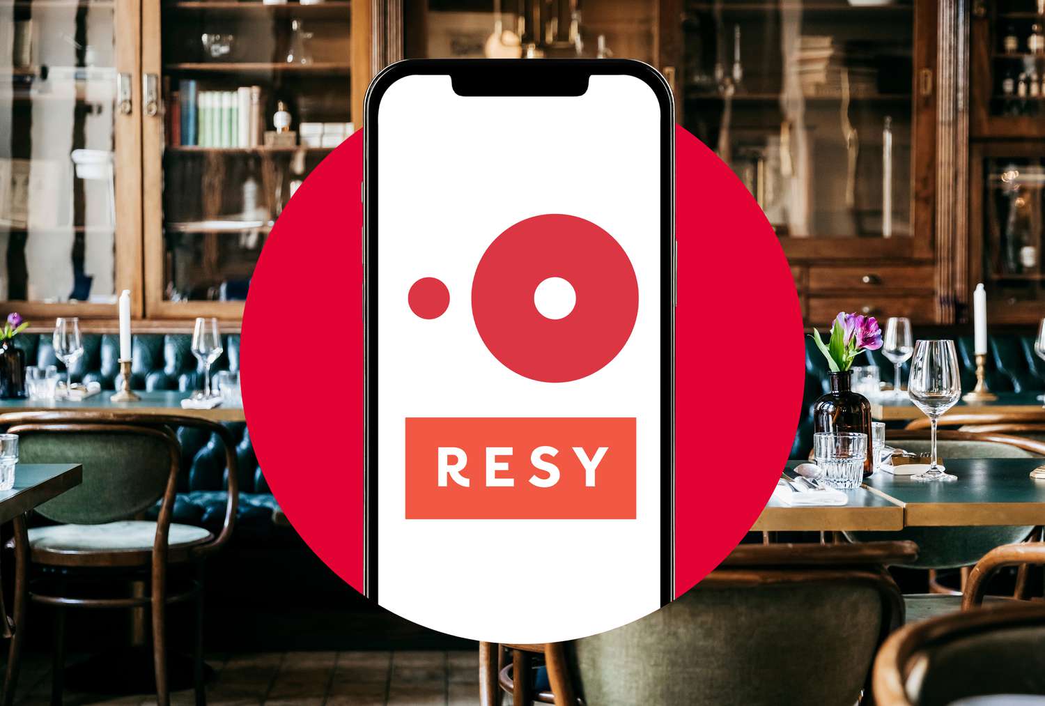 The OpenTable and RESY logos on a phone in a photo composite with an interior or a restaurant. 