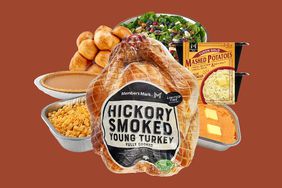 A hickory smoked turkey and various Thanksgiving items from Sam's Club including mashed potatoes, a pumpkin pie, salad, rolls, mashed sweet potatoes, and macaroni and cheese. 