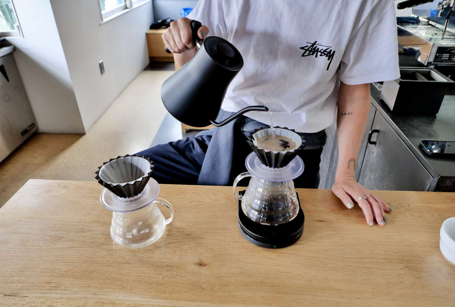 A barista pour hot water over decaf coffee grinds at Counter Culture. 