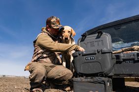 guy and dog with new yeti products