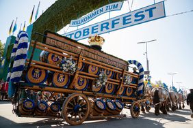 Welcome sign with the opening parade of the Oktoberfest in Munich. The Oktoberfest is the biggest beer festival of the world. 9000 participants take part with historical costumes, music bands and horses.