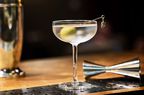 A gin martini resting on a bar