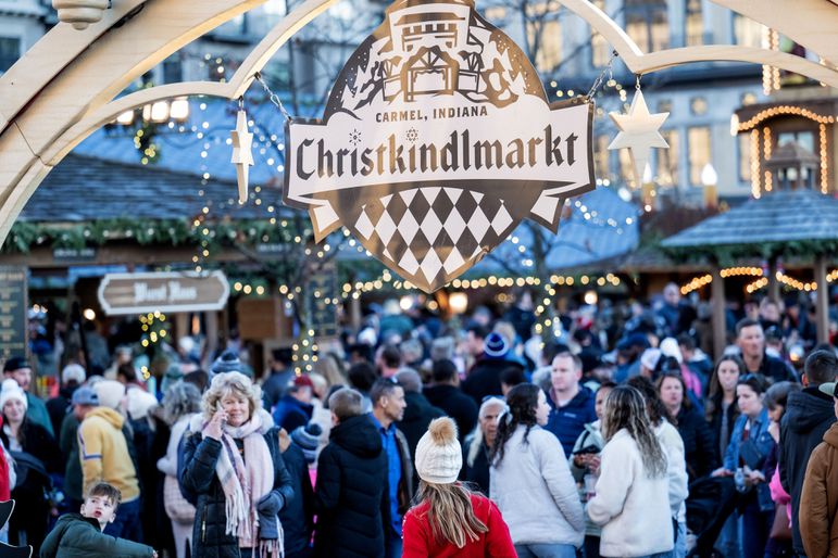 A sign and crowds at the Carmel Christkindlmarkt