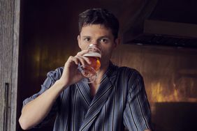 Tom Holland drinking a BERO out of a glass. 