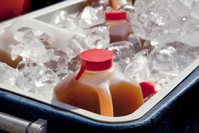 Apple Cider Jugs in a cooler filled with ice. 