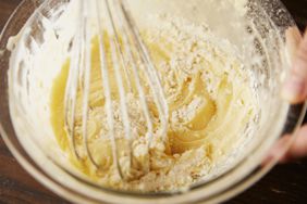 Cake batter being mixed with a whisk.