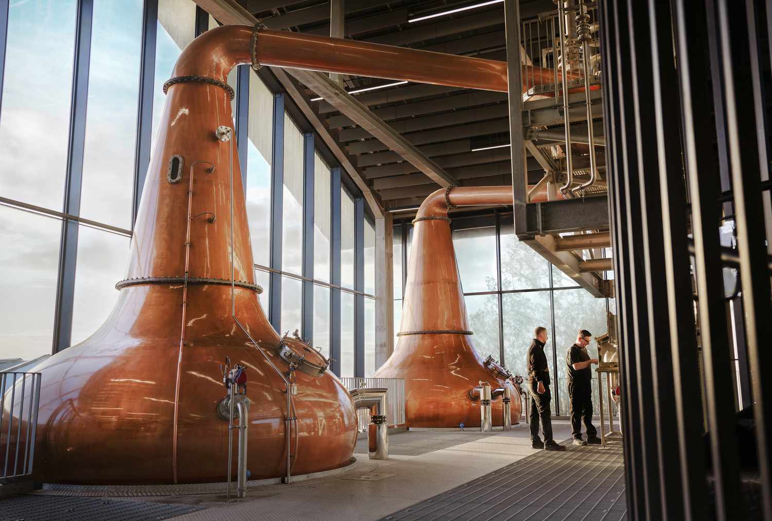 Distillery workers take the cut at the spirit safe at Port Ellen Distillery, collecting whiskey from the stills after 40 years of closure. 