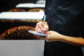 A server taking an order from customers.