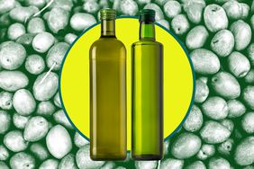 Two green olive oil bottles over a background of green olives. 